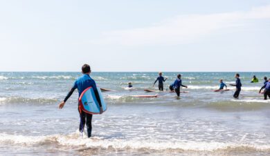 children surfing during a school residential at skern adventure