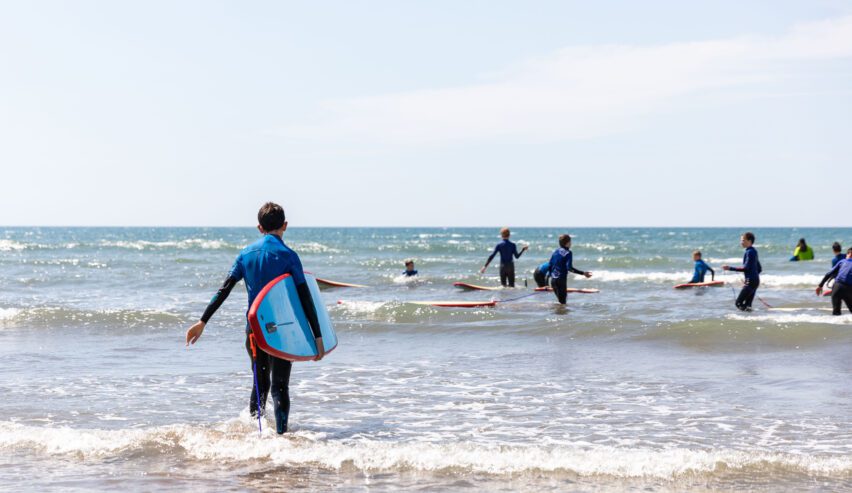 children surfing during a school residential at skern adventure