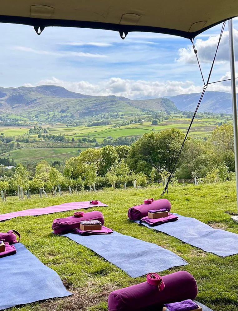 yoga matts outside with a view of the lake district around blencathra