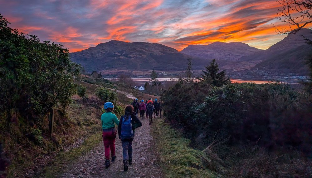 scout group walking into the sunset
