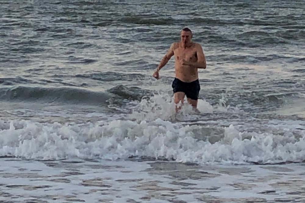 man swiming in the cold sea