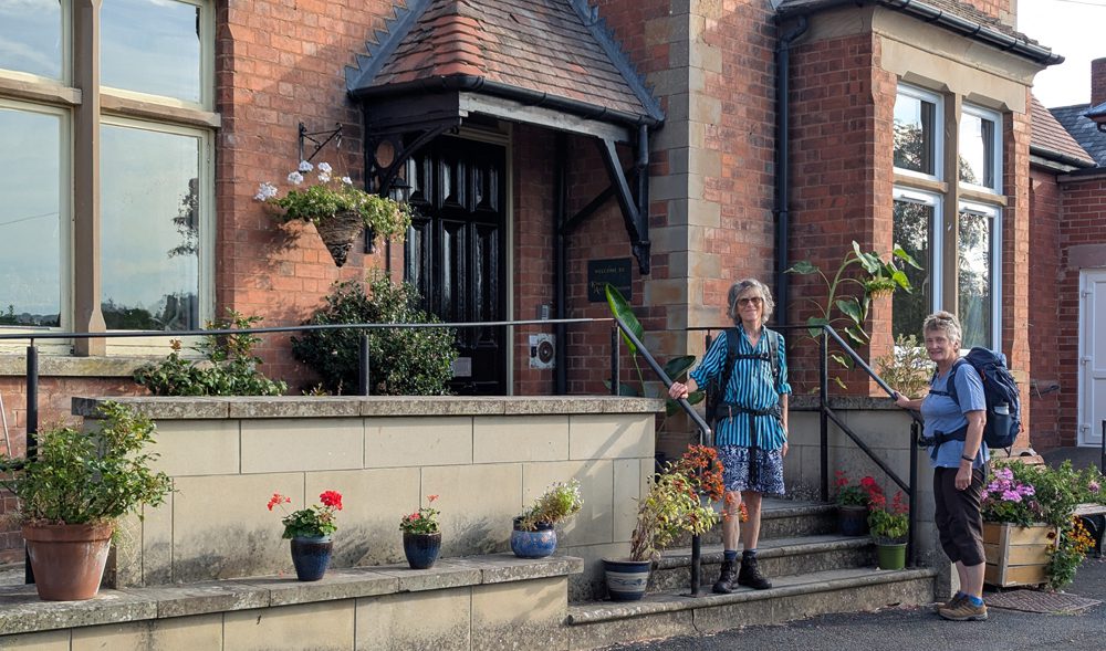 the old YHA Kington taken in 2026 with two walkers outside
