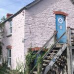 Outside of toad hall hostel accommodation showing the independent hostels sign
