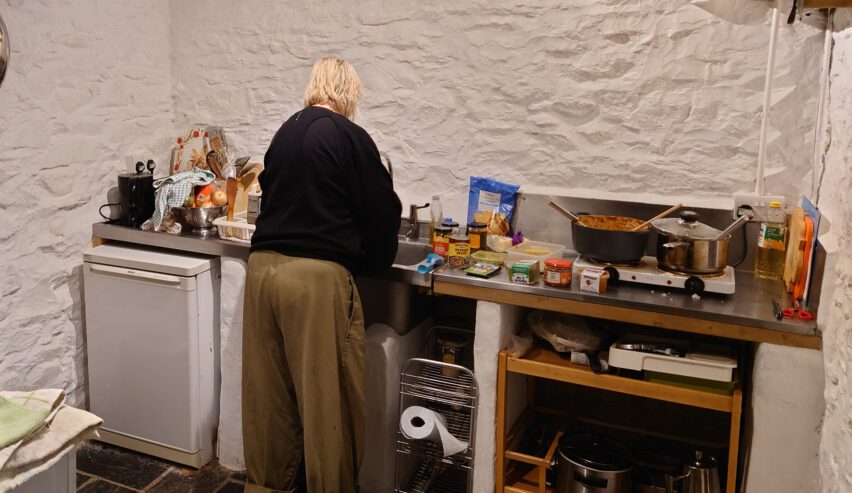lady cooking at low bridge end farm camping barn