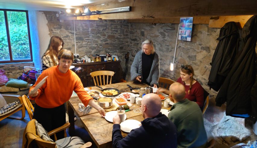 people eating a meal at low bridge end farm camping barn